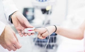 Close up of medical heart rate monitor on patients finger